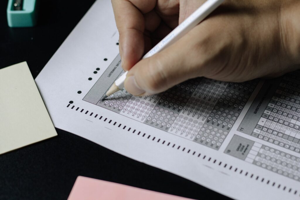 Student filling in answers with a pencil on an exam paper