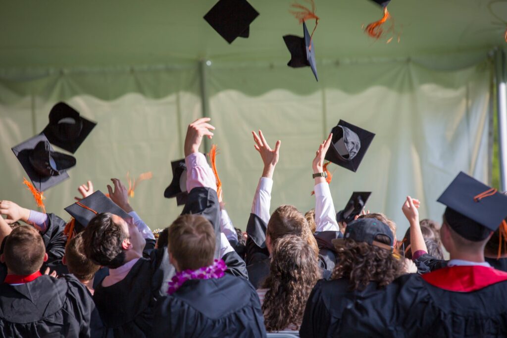 Graduating students throwing their hats into the air.