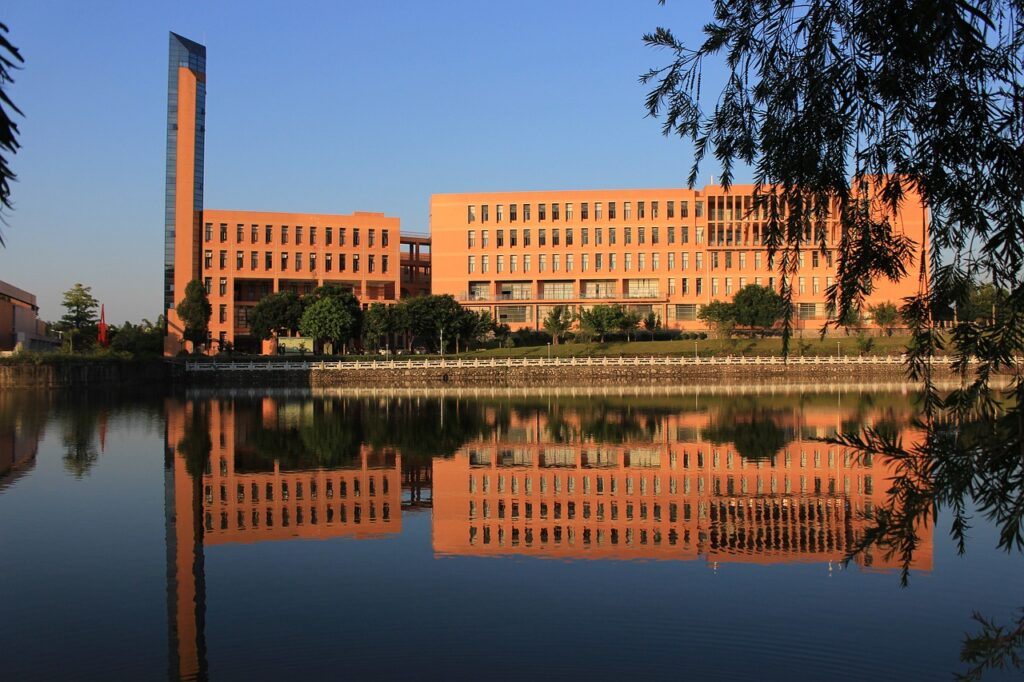 University building reflected off of a water body.